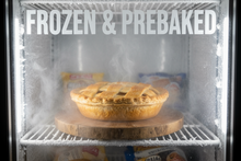 word frozen & prebaked in a freezer with a fresh pie